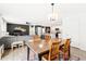 Open-concept design highlighting the dining room with a wooden table and kitchen in the background at 2512 Lily Dr, Haw River, NC 27258