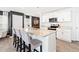 A modern kitchen features an island with bar seating, granite countertops, and ample cabinetry space at 2512 Lily Dr, Haw River, NC 27258