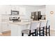 Modern kitchen with white cabinets, stainless steel appliances, and a granite island with breakfast bar at 2512 Lily Dr, Haw River, NC 27258