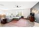 Spacious living room featuring a cozy gray sectional, elegant décor, and plenty of natural light at 2512 Lily Dr, Haw River, NC 27258