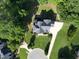 Aerial view of a home with a landscaped yard, long driveway, and mature trees on a large lot at 2514 Mcgowan Ct, Wake Forest, NC 27587