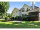 A large backyard with a brick patio, screened porch, and lush landscaping in a natural setting at 2514 Mcgowan Ct, Wake Forest, NC 27587