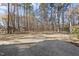 Large backyard with a large patio perfect for entertaining surrounded by mature trees at 2514 Mcgowan Ct, Wake Forest, NC 27587