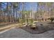 A paved patio with a decorative tree offers an intimate outdoor space amidst the privacy of surrounding trees and landscaping at 2514 Mcgowan Ct, Wake Forest, NC 27587