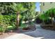 A winding stone path leads through a meticulously landscaped backyard with a small water feature and palm tree at 2514 Mcgowan Ct, Wake Forest, NC 27587