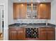 Elegant dry bar with granite countertops, tile backsplash, and wine storage at 2514 Mcgowan Ct, Wake Forest, NC 27587