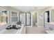 Bright primary bathroom with a large soaking tub, enclosed shower, toilet and large view windows at 2514 Mcgowan Ct, Wake Forest, NC 27587