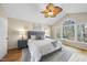 Large bedroom with vaulted ceiling, hardwood floors, decorative ceiling fan and bright sunny windows at 2514 Mcgowan Ct, Wake Forest, NC 27587
