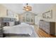 Spacious bedroom with vaulted ceiling, large windows and a stylish dresser with light hardwood floors at 2514 Mcgowan Ct, Wake Forest, NC 27587
