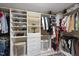 Walk-in closet with custom shelving, hanging rods and ample storage for organizing clothes and shoes at 2514 Mcgowan Ct, Wake Forest, NC 27587