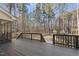 A spacious wooden deck offers serene views of the surrounding wooded area, ideal for outdoor relaxation and entertainment at 2514 Mcgowan Ct, Wake Forest, NC 27587