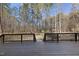 A wooden deck area leads to the wooded yard offering a private and inviting outdoor living space at 2514 Mcgowan Ct, Wake Forest, NC 27587