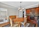 Bright dining room with wood table, built-in cabinets, and hardwood floors on decorative rug at 2514 Mcgowan Ct, Wake Forest, NC 27587