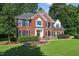 Charming two-story brick home with lush landscaping and a welcoming front porch in a well-manicured yard at 2514 Mcgowan Ct, Wake Forest, NC 27587