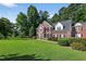 Attractive brick home with a well-maintained lawn, mature trees, and classic architectural details at 2514 Mcgowan Ct, Wake Forest, NC 27587