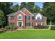 Charming two-story brick home with a lush green lawn, black shutters, and a welcoming front porch at 2514 Mcgowan Ct, Wake Forest, NC 27587