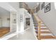 Bright foyer with staircase featuring wood treads, iron railings and light tile flooring at 2514 Mcgowan Ct, Wake Forest, NC 27587