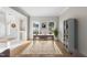 Bright home office with large windows, hardwood floors, stylish rug, and modern desk creates an inspiring workspace at 2514 Mcgowan Ct, Wake Forest, NC 27587