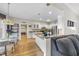 Open kitchen with island and stainless steel appliances, seamlessly flowing from the living room at 2514 Mcgowan Ct, Wake Forest, NC 27587