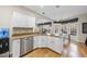 Kitchen island with granite counters, stainless dishwasher, and white cabinets overlooking breakfast nook and sunroom at 2514 Mcgowan Ct, Wake Forest, NC 27587