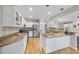 Bright kitchen featuring stainless appliances, granite counters, white cabinetry, and hardwood floors at 2514 Mcgowan Ct, Wake Forest, NC 27587