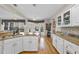 Open kitchen with white cabinets, granite countertops, stainless steel appliances, and breakfast nook view at 2514 Mcgowan Ct, Wake Forest, NC 27587
