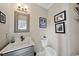Stylish powder room with modern fixtures, marble vanity top, and decorative mirror at 2514 Mcgowan Ct, Wake Forest, NC 27587