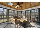 Cozy sunroom with skylights, wood paneled ceiling and multiple seating areas at 2514 Mcgowan Ct, Wake Forest, NC 27587