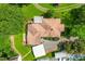 Aerial view of a home featuring a well-manicured lawn, a shed, and a large carport at 2616 Bullock Rd, Durham, NC 27704