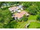 Aerial view of a house with a well-maintained lawn, carport, and mature trees at 2616 Bullock Rd, Durham, NC 27704
