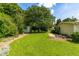Spacious backyard with mature trees, a shed, and a well-manicured lawn at 2616 Bullock Rd, Durham, NC 27704