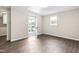 Bedroom with wood floors, outside access to the porch and ample natural light at 2616 Bullock Rd, Durham, NC 27704