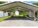 Gravel carport with white metal awning and a white storage shed at the back of the property at 2616 Bullock Rd, Durham, NC 27704