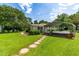 Well-maintained lawn with stepping stones leading up to the home and carport at 2616 Bullock Rd, Durham, NC 27704