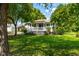 Quaint one-story home with a covered front porch and a lush green lawn, shaded by mature trees at 2616 Bullock Rd, Durham, NC 27704