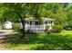Charming one-story home featuring a welcoming front porch and beautifully landscaped front yard with lush greenery at 2616 Bullock Rd, Durham, NC 27704