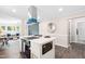 Modern kitchen with stainless steel appliances, a center island, and views into the living area at 2616 Bullock Rd, Durham, NC 27704
