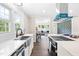 Stylish kitchen featuring stainless steel appliances, white cabinetry, and an eat-in breakfast bar at 2616 Bullock Rd, Durham, NC 27704