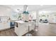 Open kitchen with a center island, stainless appliances, white cabinetry, and an eat-in breakfast bar at 2616 Bullock Rd, Durham, NC 27704
