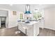 Bright kitchen features an island with breakfast bar, modern appliances, and white cabinets at 2616 Bullock Rd, Durham, NC 27704