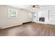 Bright living room with fireplace, built-in shelves, and wood flooring at 2616 Bullock Rd, Durham, NC 27704