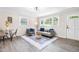 Bright and airy living room featuring modern furnishings, large windows, and stylish decor with lots of natural light at 2616 Bullock Rd, Durham, NC 27704