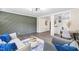 Spacious living room with a unique accent wall, modern furniture, and an open view to the kitchen at 2616 Bullock Rd, Durham, NC 27704