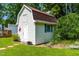Charming white storage shed with a red star accent and well-kept landscaping at 2616 Bullock Rd, Durham, NC 27704