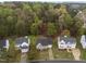 Aerial view of a home in a lush, wooded neighborhood, showcasing its serene setting at 2825 Alder Ridge Ln, Raleigh, NC 27603