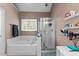 Well-lit bathroom with a soaking tub, glass shower and ample storage space at 2825 Alder Ridge Ln, Raleigh, NC 27603