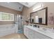 Bright bathroom with a large soaking tub, separate shower, double sink vanity, and natural light at 2825 Alder Ridge Ln, Raleigh, NC 27603