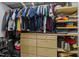 Organized walk-in closet with custom shelving, drawers, and hanging rods for optimal storage at 2825 Alder Ridge Ln, Raleigh, NC 27603