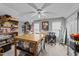 Well-lit craft room with large table, ample storage shelves, and ceiling fan at 2825 Alder Ridge Ln, Raleigh, NC 27603