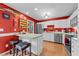 Bright kitchen with white cabinetry, stainless steel appliances, and a breakfast bar area at 2825 Alder Ridge Ln, Raleigh, NC 27603